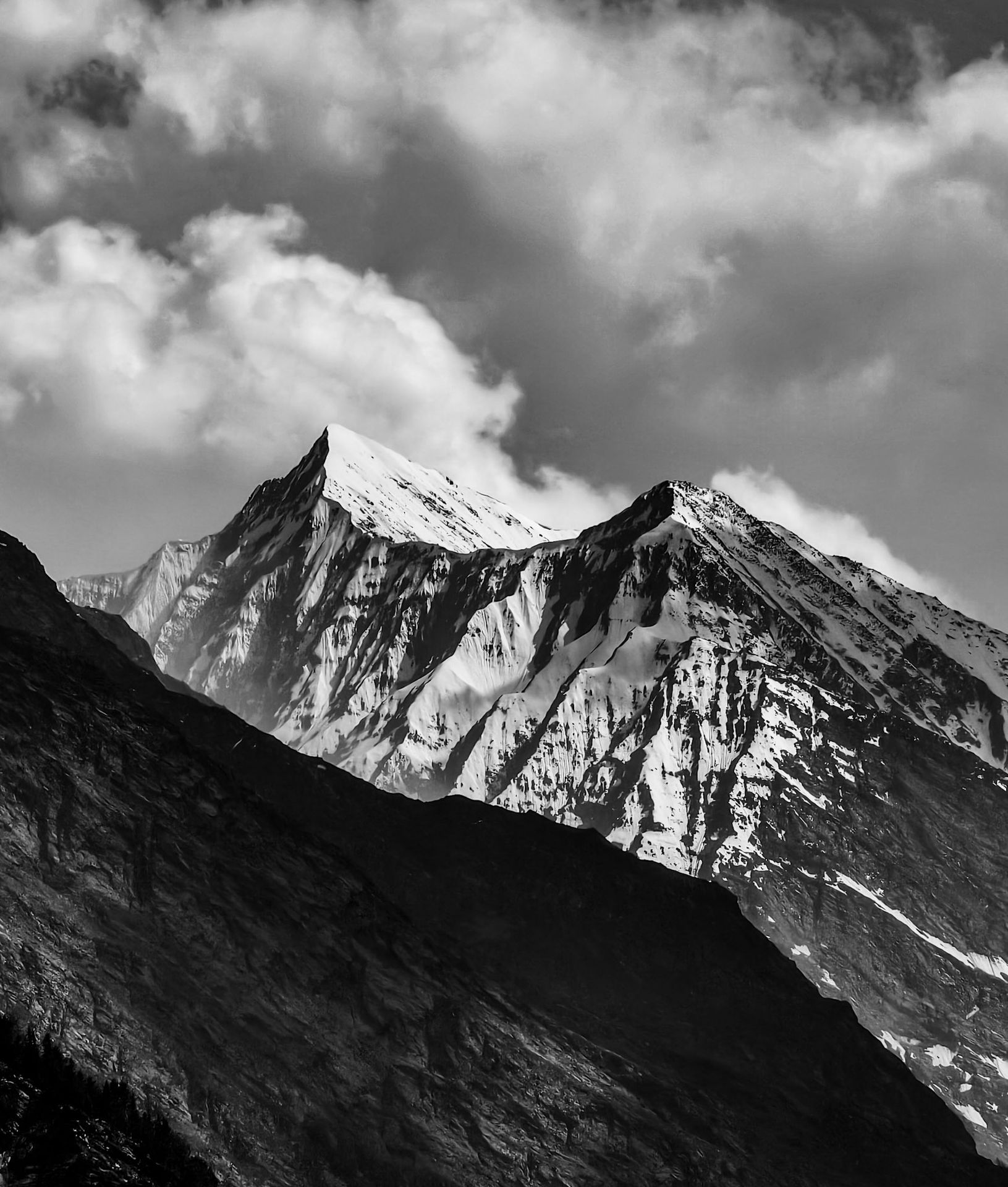 A snow capped mountain with a beautiful shape in the lahaul valley